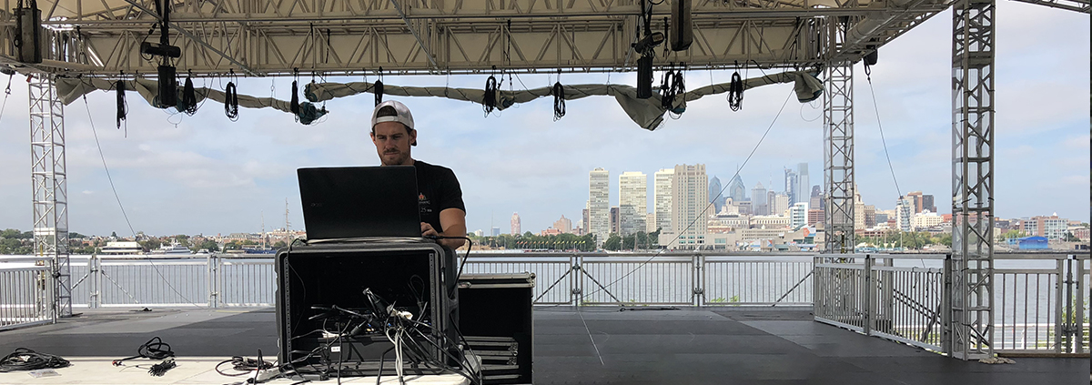 technician operating a philadelphia led screen rental in front of the skyline